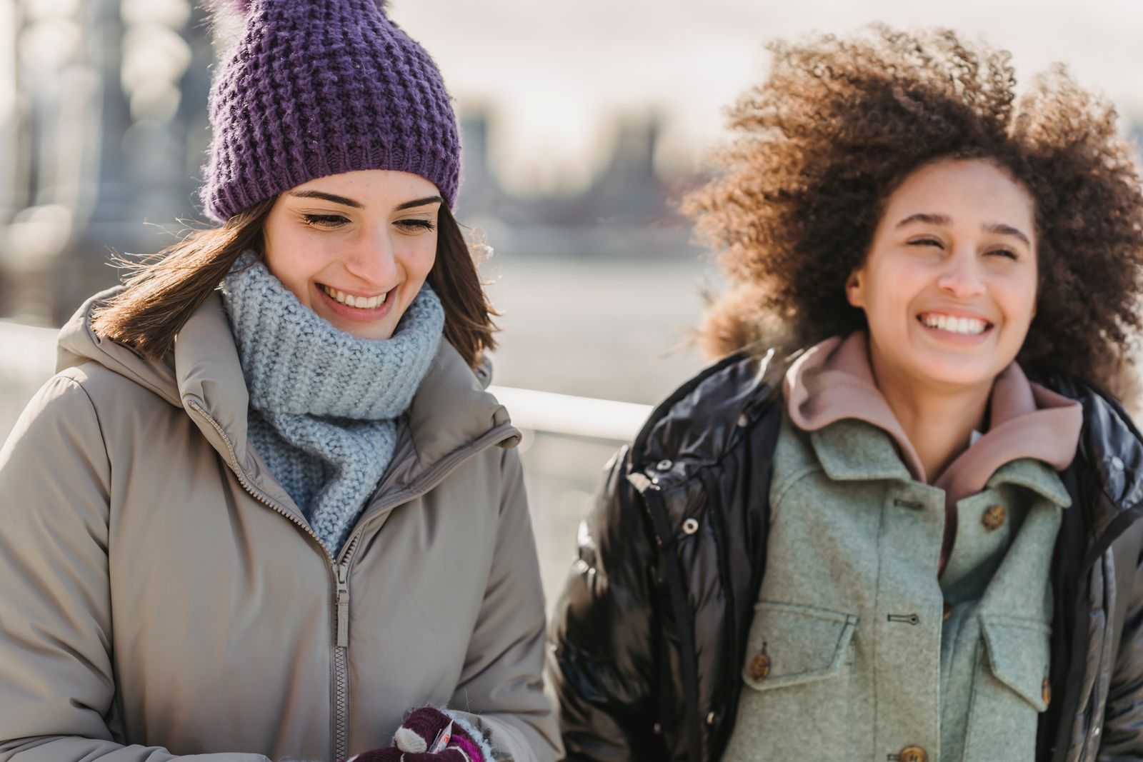 Two women smiling as they walk together outdoors